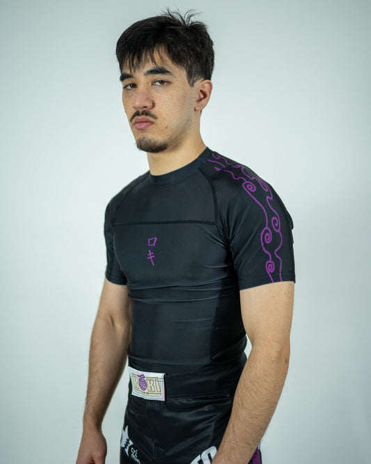 Front view of a model wearing a black Roki Awakened compression shirt