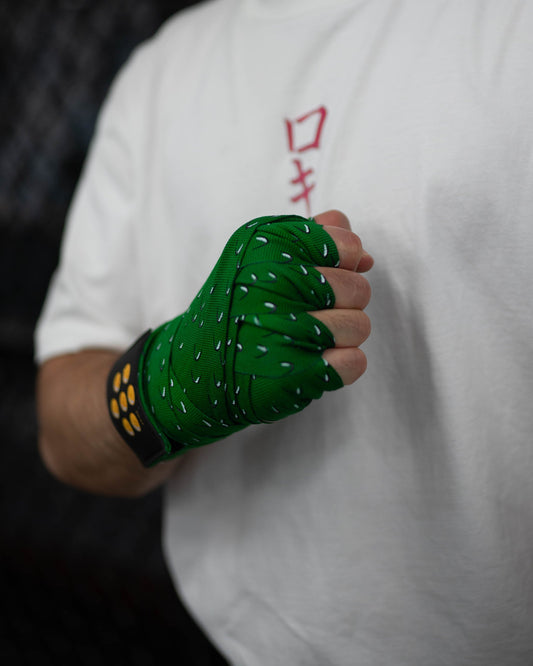 dragon ball inspired boxing hand wraps in action, green scale pattern and seven-star patch wrapped on hand with fist clenched
