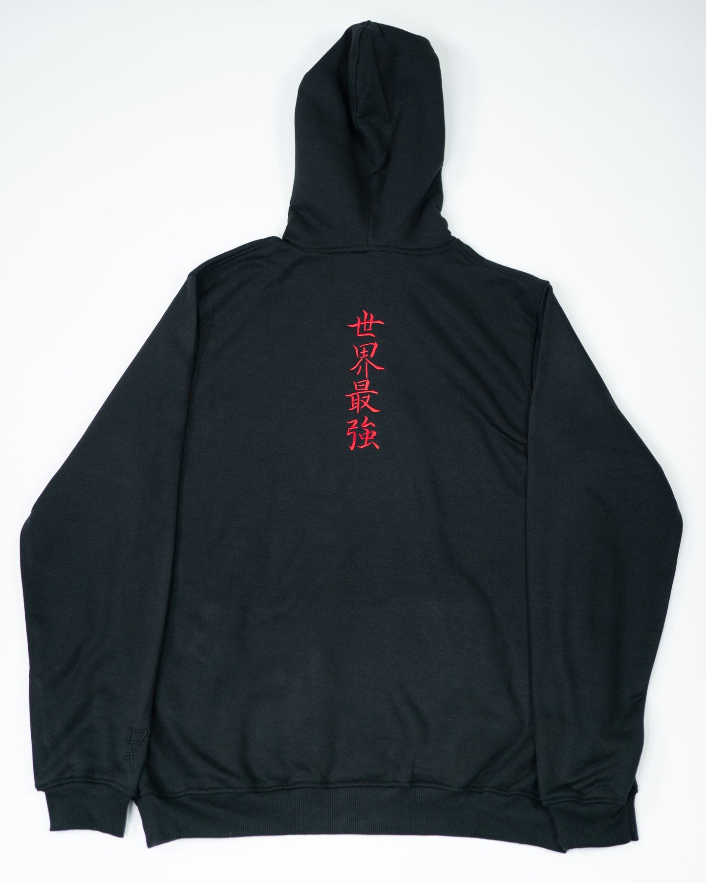 Flatlay of Sekai Saikyo Hoodie showing full back with red embroidered kanji centered on black heavyweight fabric
