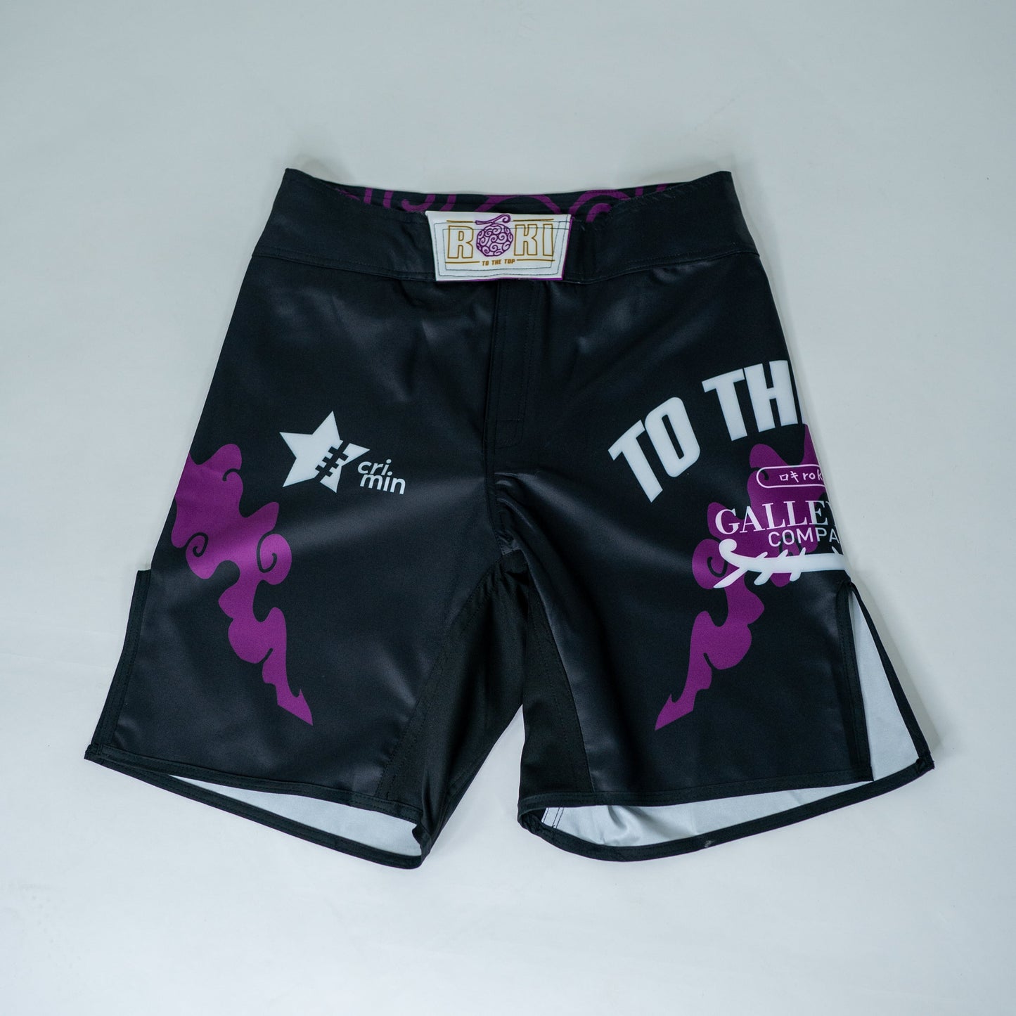 Front view of Roki grand line fight shorts, featuring purple accents, Roki logo, and manga-inspired sponsor logos