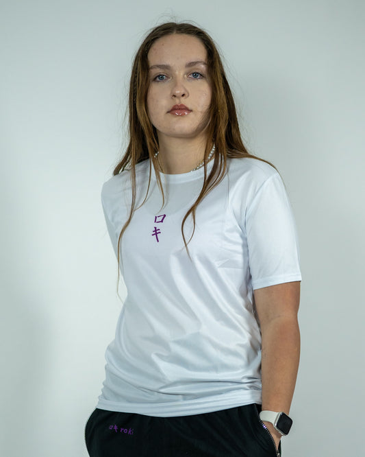 Front view of model wearing a white Roki Liberation training shirt featuring a purple Roki logo