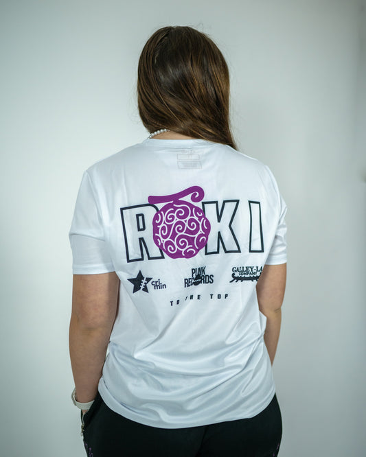 Back view of a model wearing a white Roki Liberation training shirt with anime-inspired sponsor logos