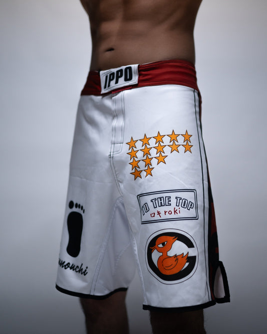 Model wearing Ippo Fight Shorts featuring anime-inspired prints and red waistband — Hajime no Ippo training gear