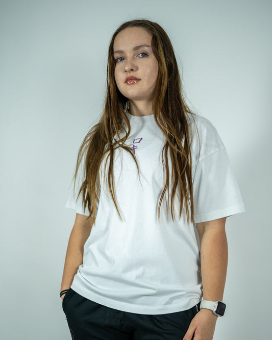 Front view of a model wearing a white Roki muki muki oversized t-shirt featuring a purple Roki logo