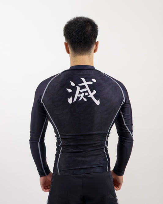 demon slayer rash guard being worn by man, back view of design