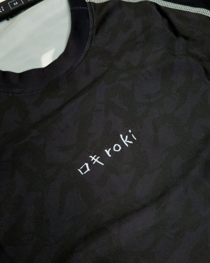 Black rash guard with 'roki' logo on a white background