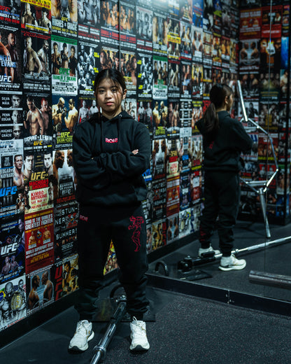 Female fighter wearing Baki anime hoodie and joggers