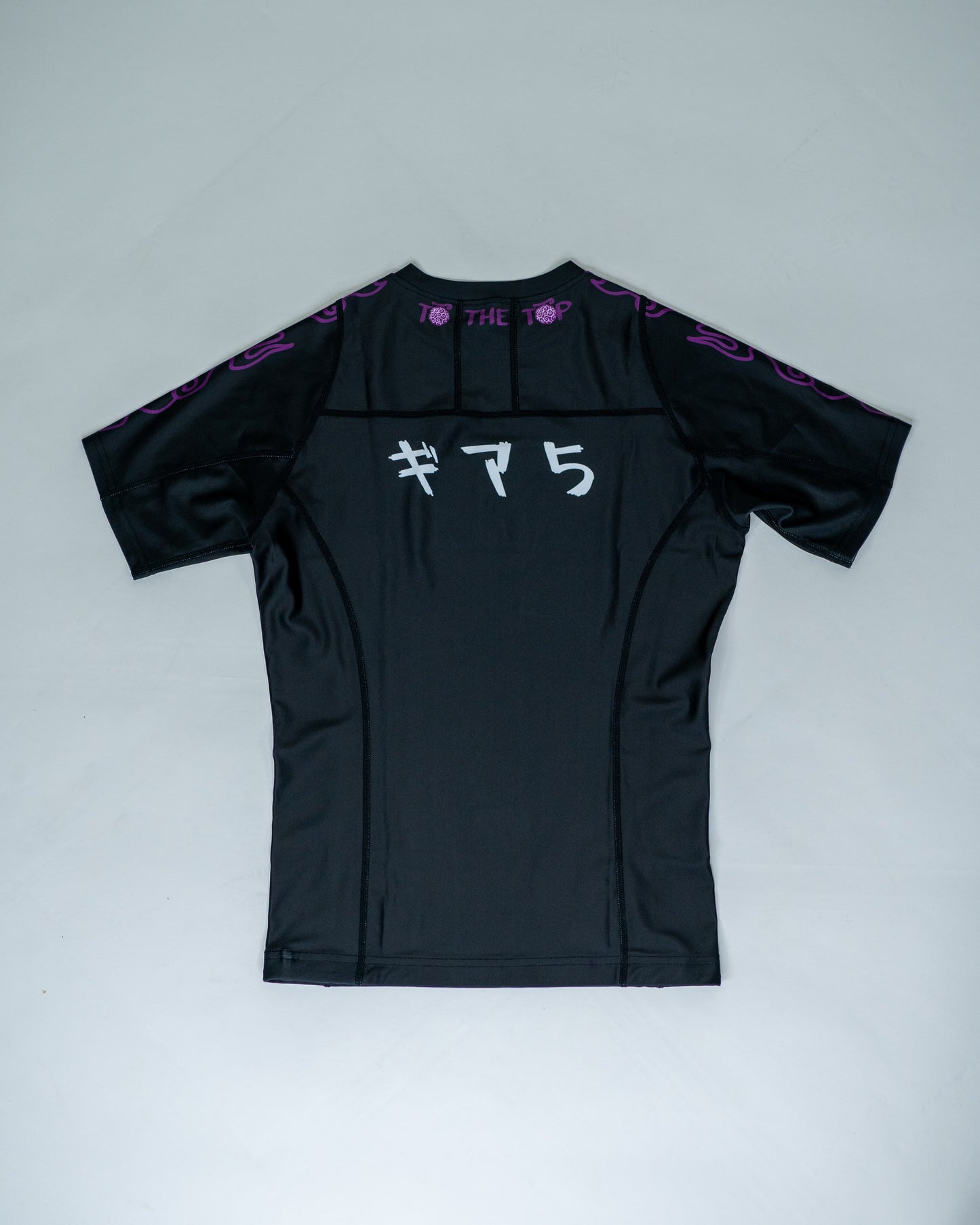 Back view of a black Roki Awakened compression shirt featuring Japanese text