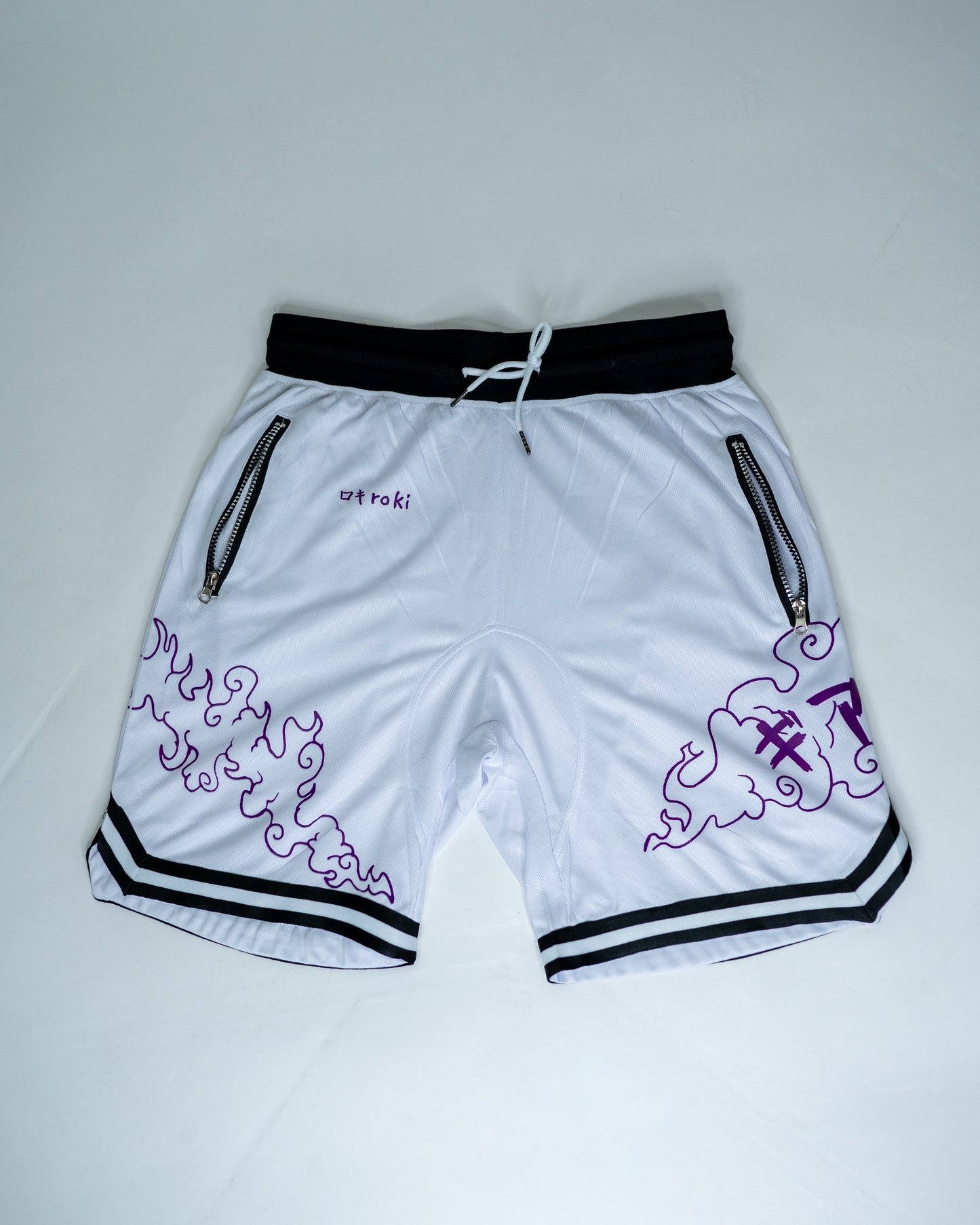 Front view of white Roki Awakened gym shorts featuring purple accents and Roki logo