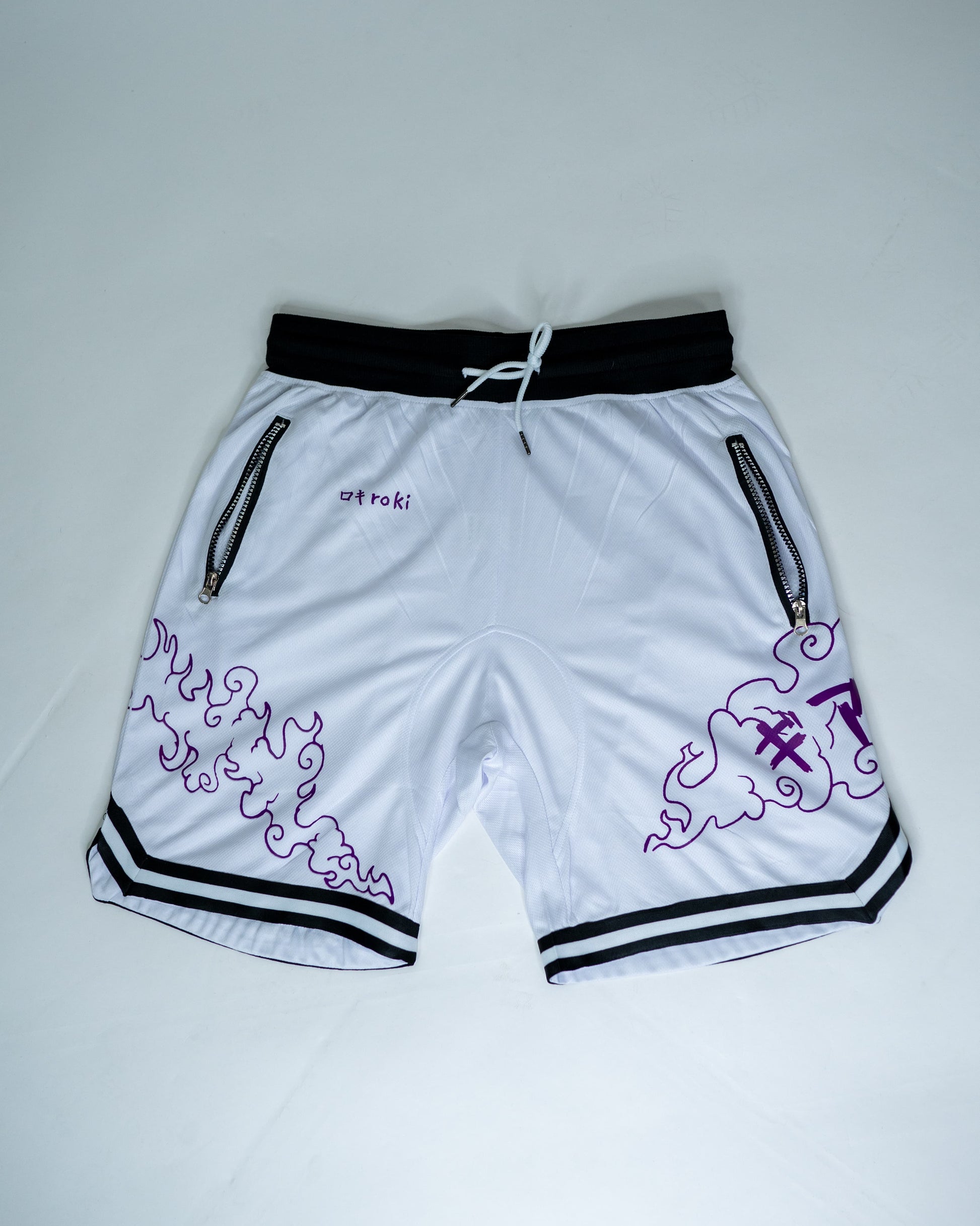 Front view of white Roki Awakened gym shorts featuring purple accents and Roki logo