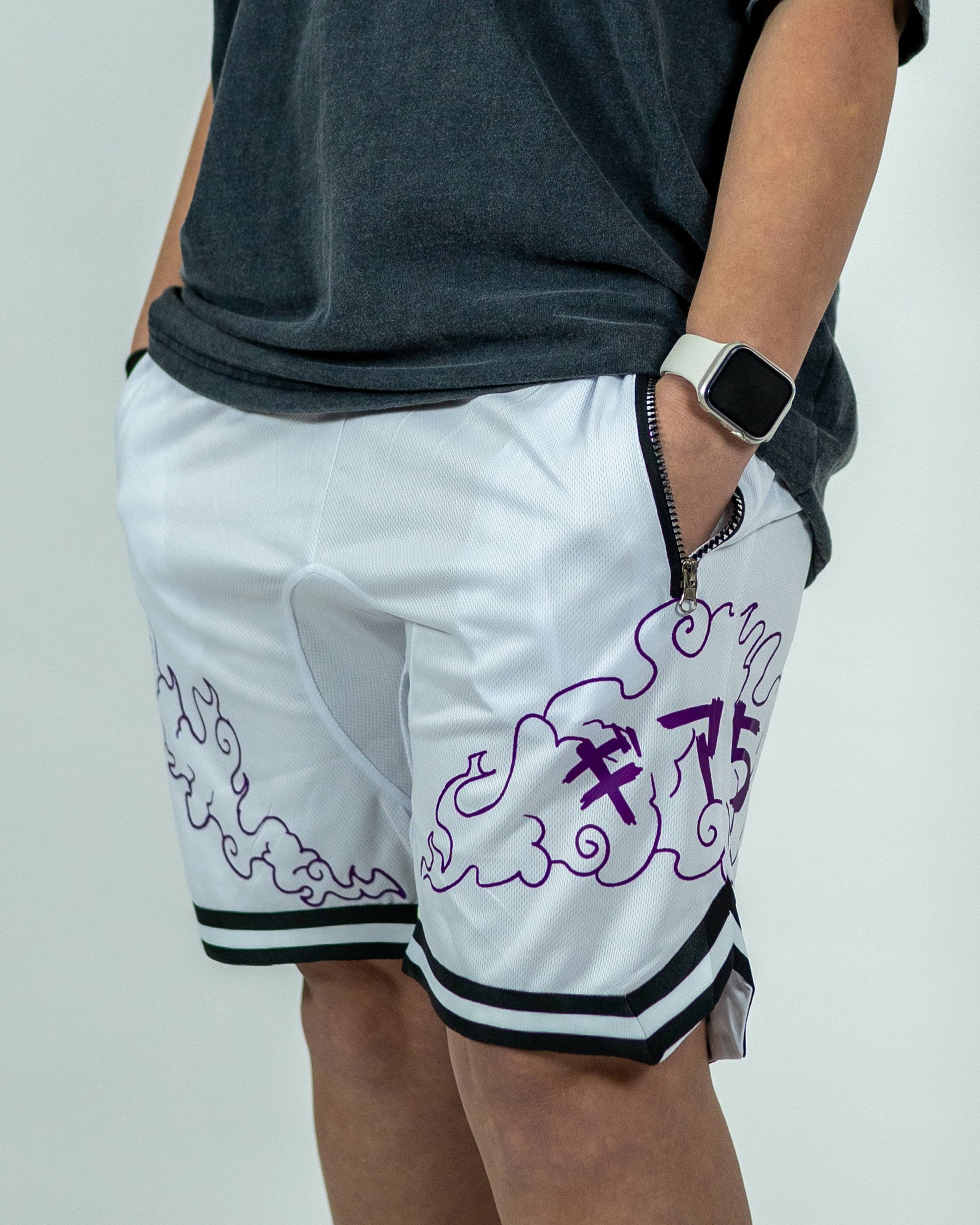 Side close-up of a model wearing white Roki Awakened gym shorts featuring purple accents and Roki logo