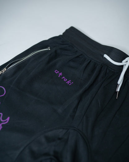 Close-up of black Roki Awakened gym shorts featuring purple accents and Roki logo