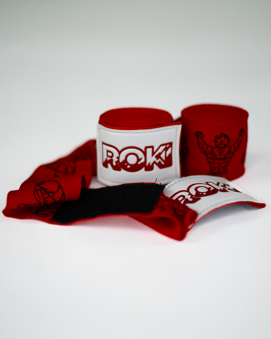 baki inspired red boxing hand wraps with anime grappler illustrations and bold roki patch, partially unrolled on white background