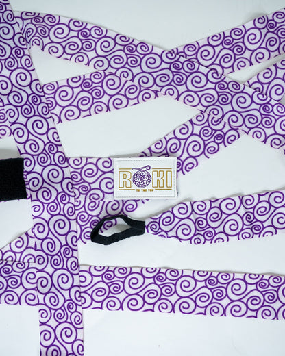 Roki gomu hand wraps laid out, featuring purple accents, roki logo, thumb-loop and velcro patch