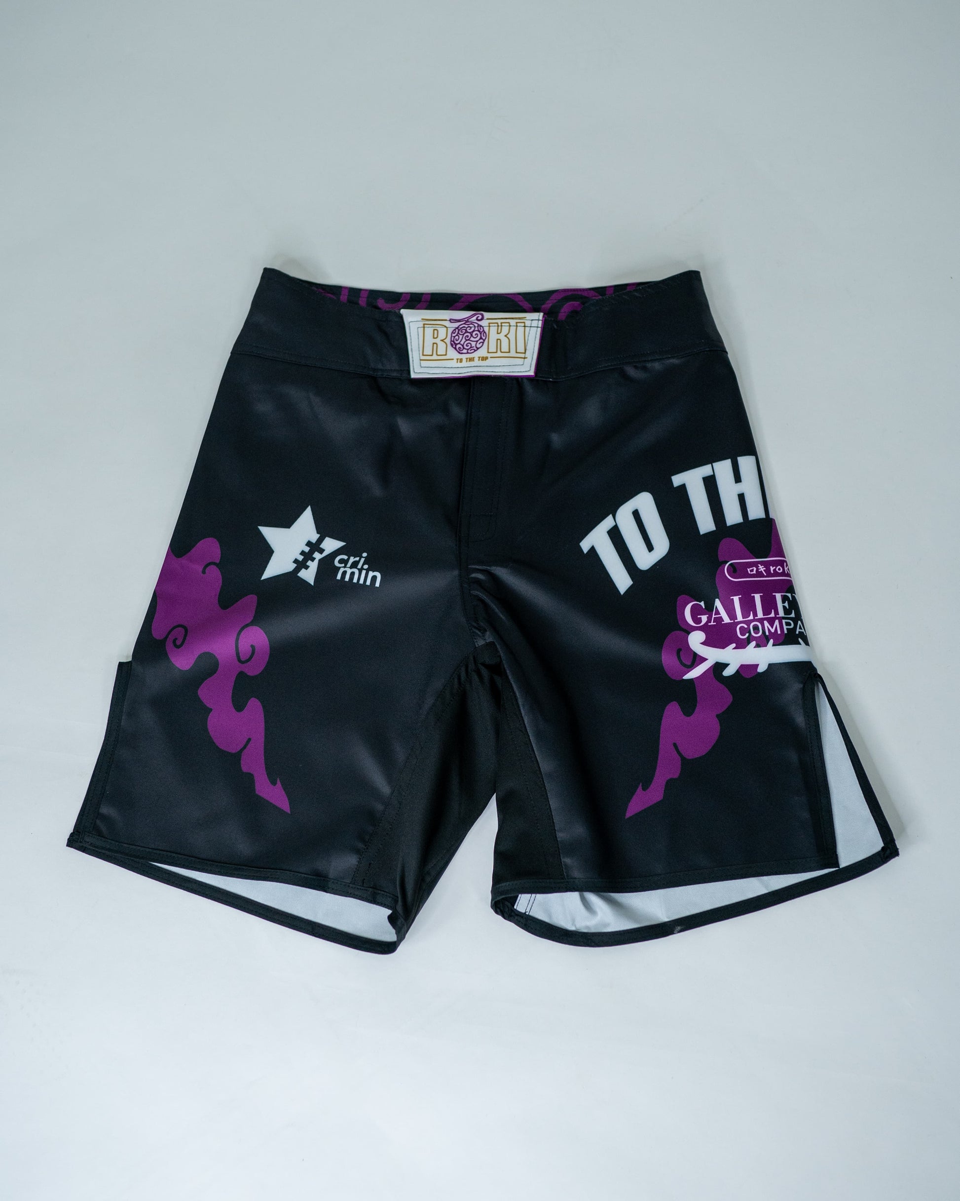 Front view of Roki grand line fight shorts, featuring purple accents, Roki logo, and manga-inspired sponsor logos
