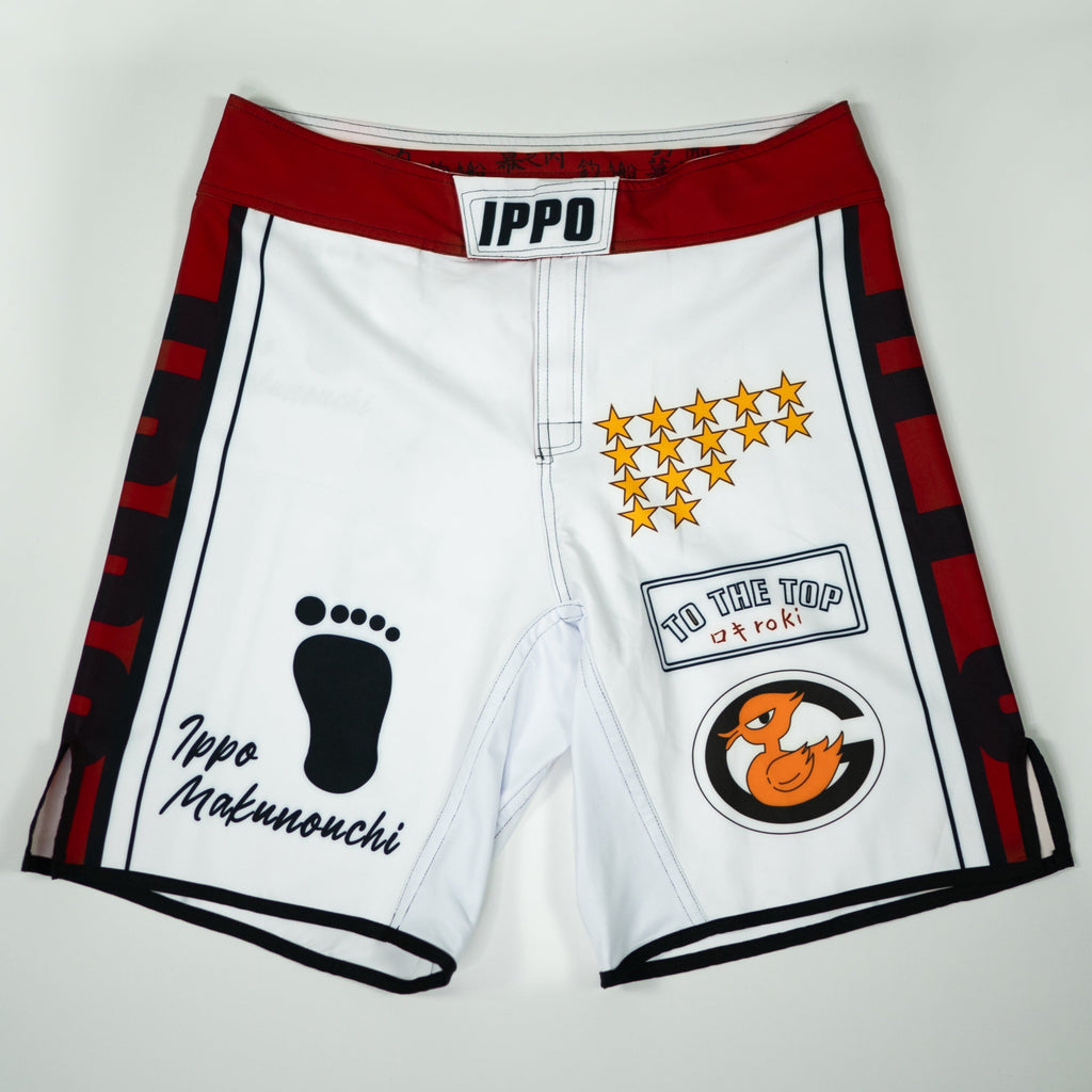 Front view of Ippo Fight Shorts featuring red waistband, character art, and Hajime no Ippo inspired design details