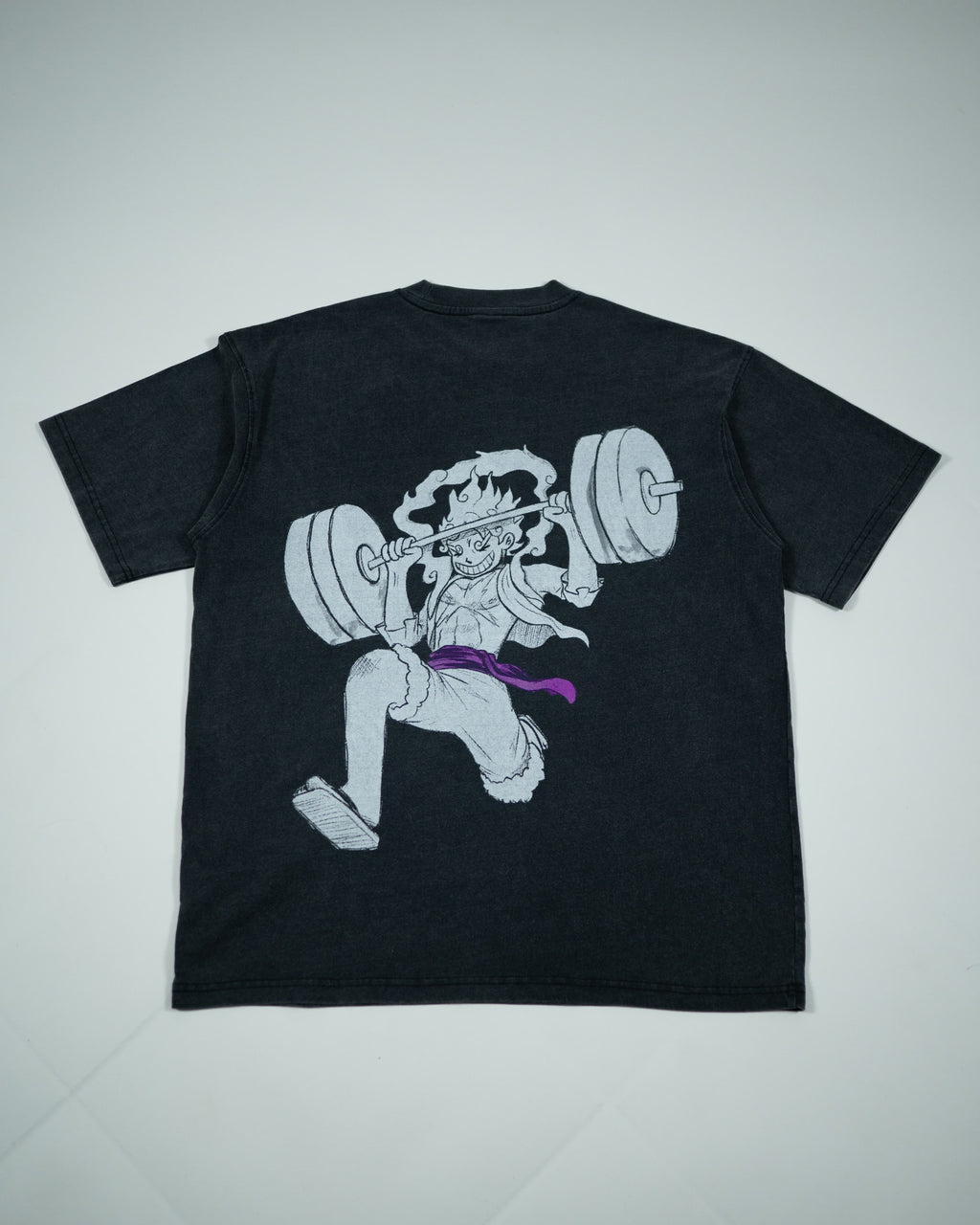 Back view of a black Roki muki muki oversized t-shirt featuring a manga-inspired design