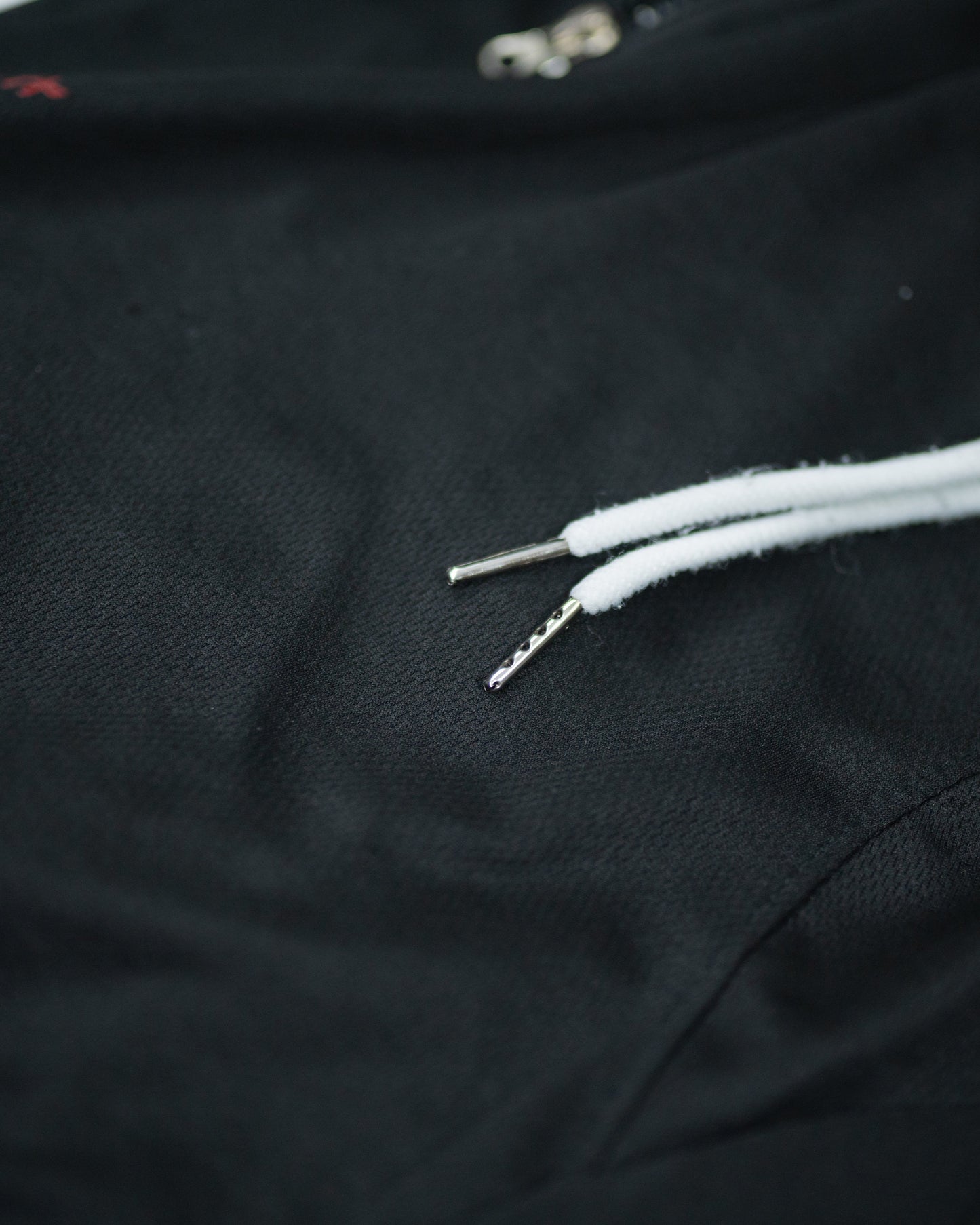 Close-up of white drawstrings and textured waistband on Roki Gym Short