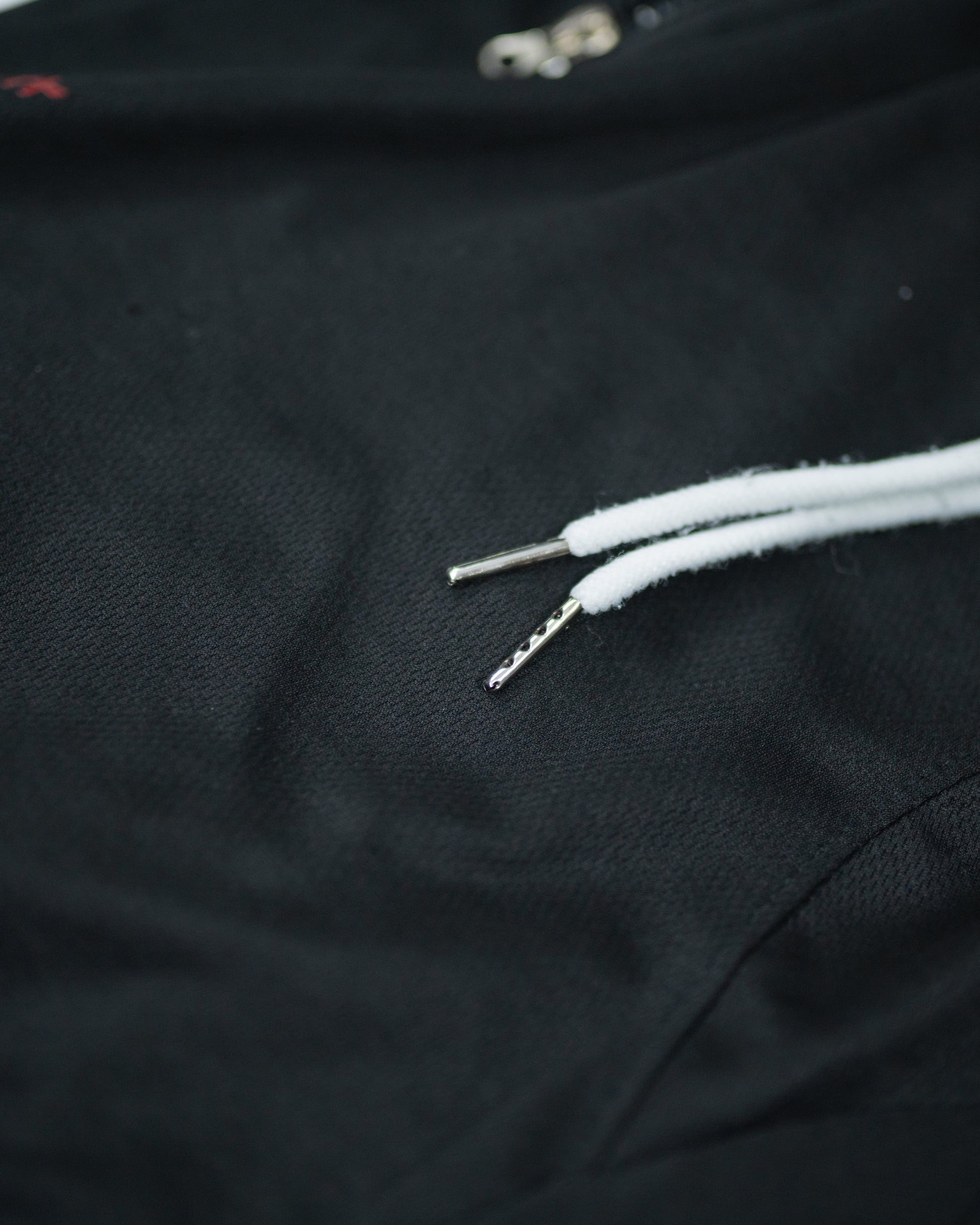 Close-up of white drawstrings and textured waistband on Roki Gym Short