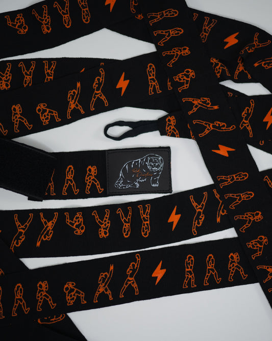 Flat lay of Sendo boxing hand wraps showing orange fighter graphics and thumb loop