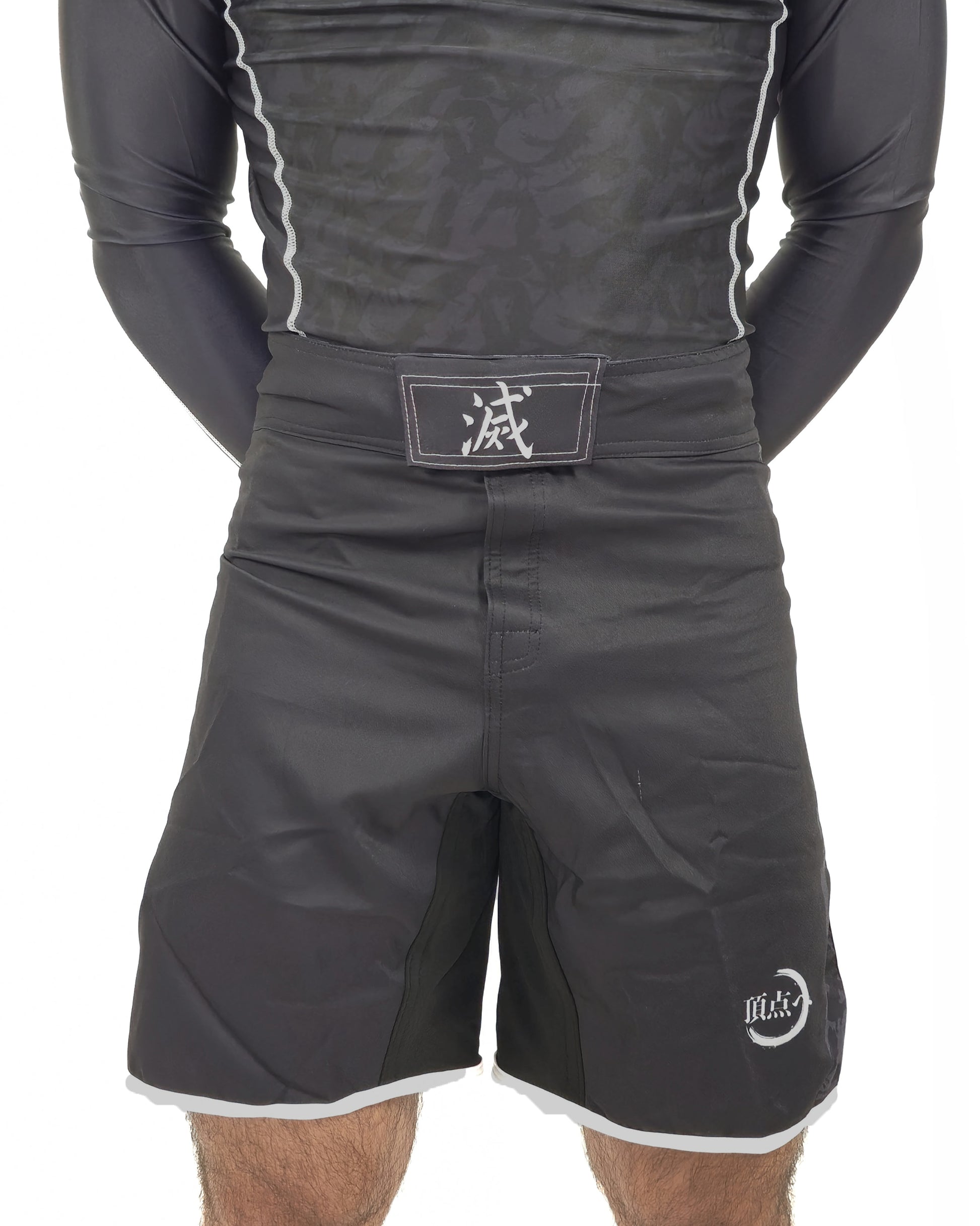 Black mma shorts with a belt and visible brand logo on a white background, demon slayer style