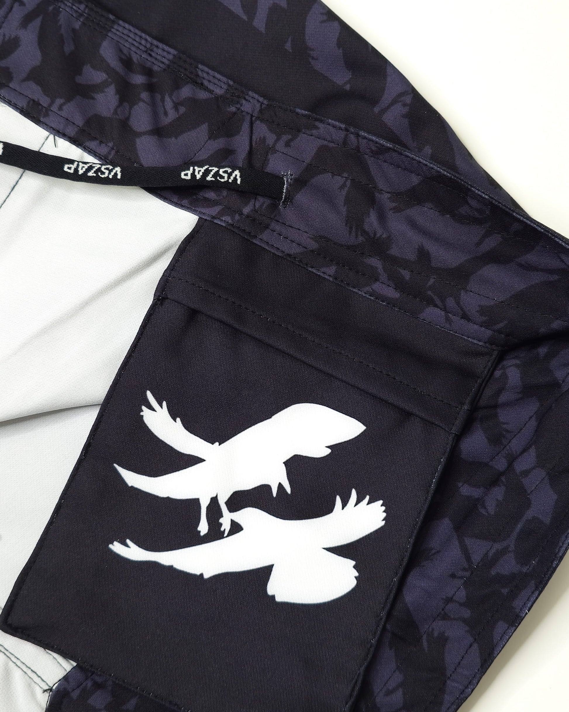 Black inner pocket with white crow design and visible brand logo on a light background