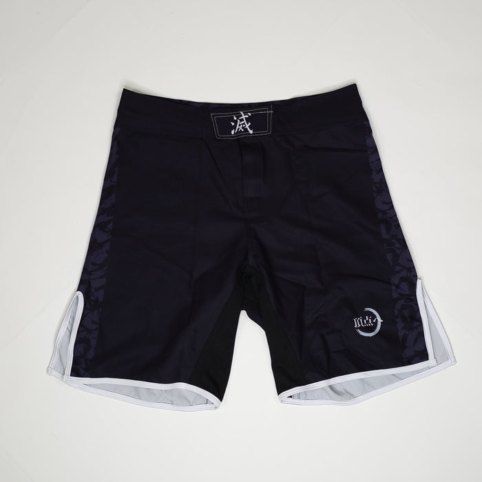 Black demon slayer shorts with white accents on a light gray background